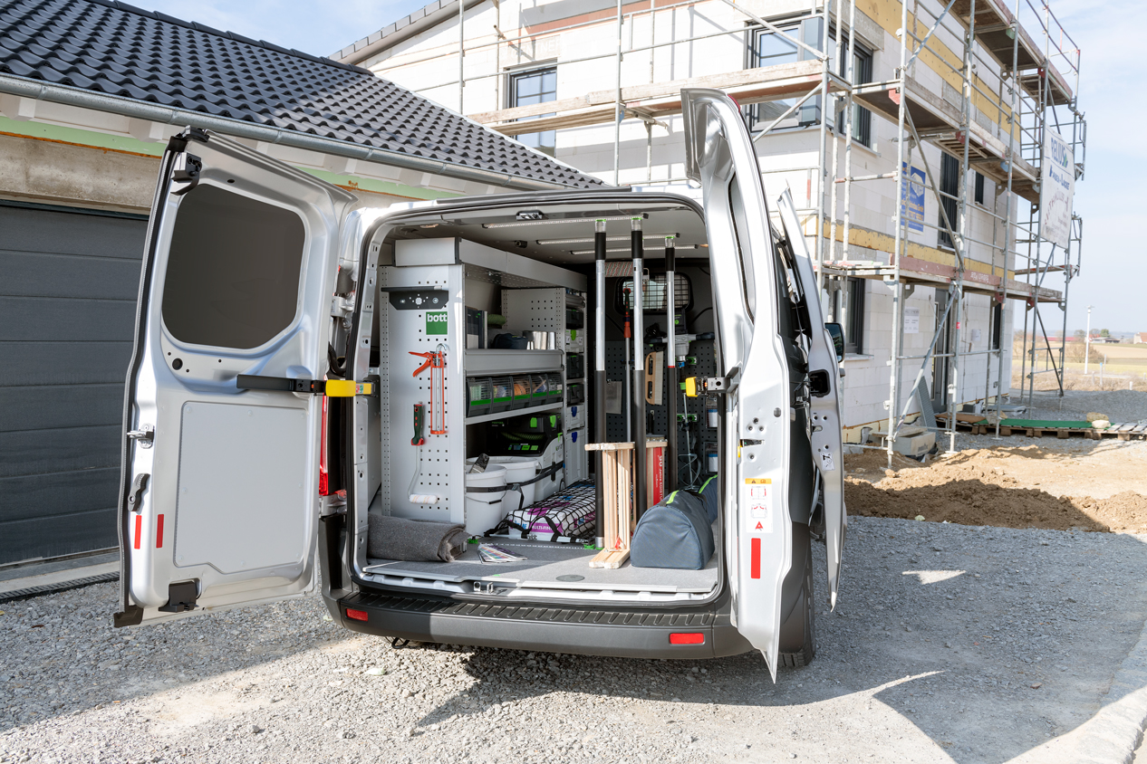 van racking inside van - doors open on contruction site - custom van racking from bott ltd