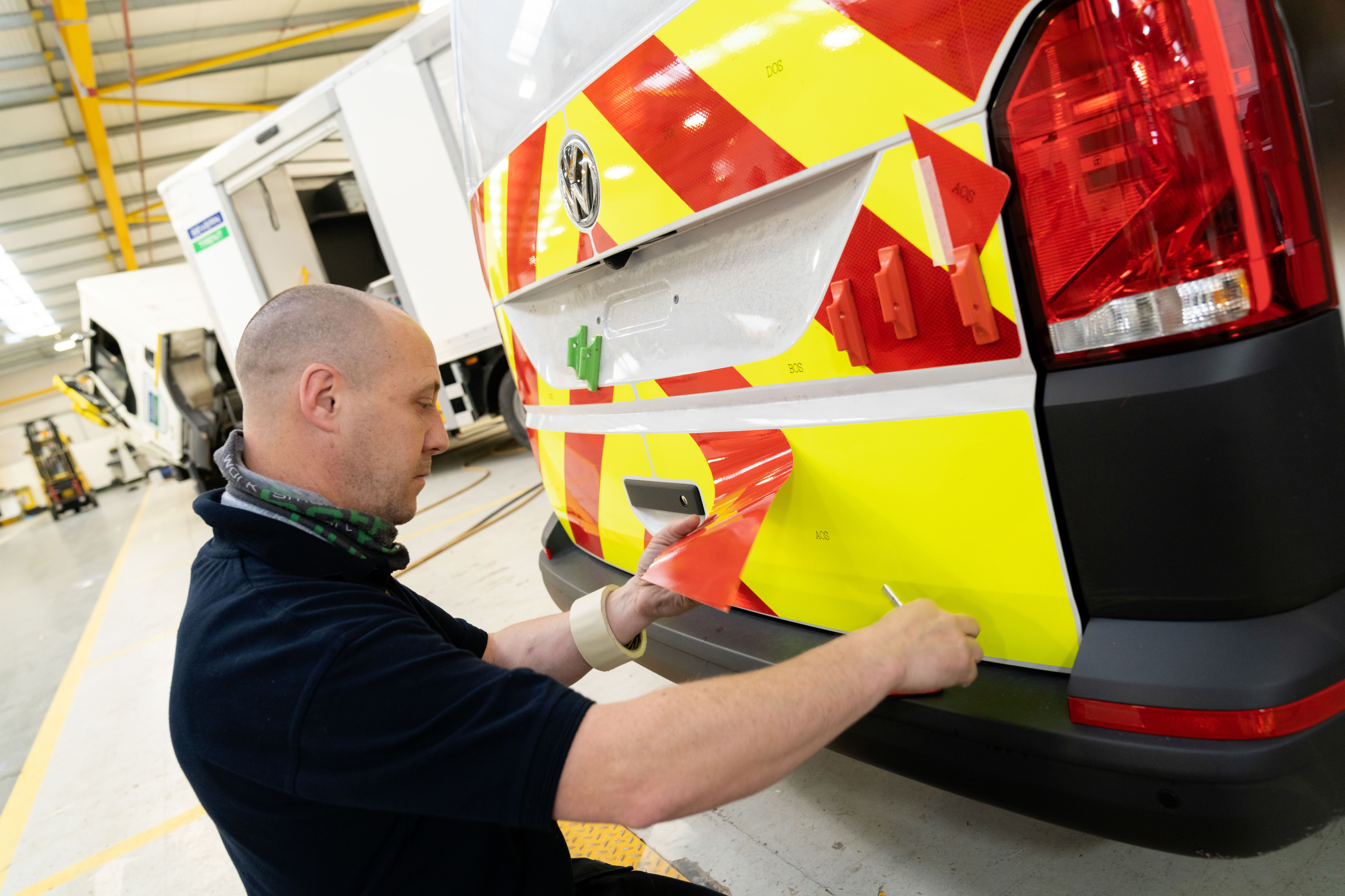 man fitting van graphics to van - van decals & van wrapping by bott