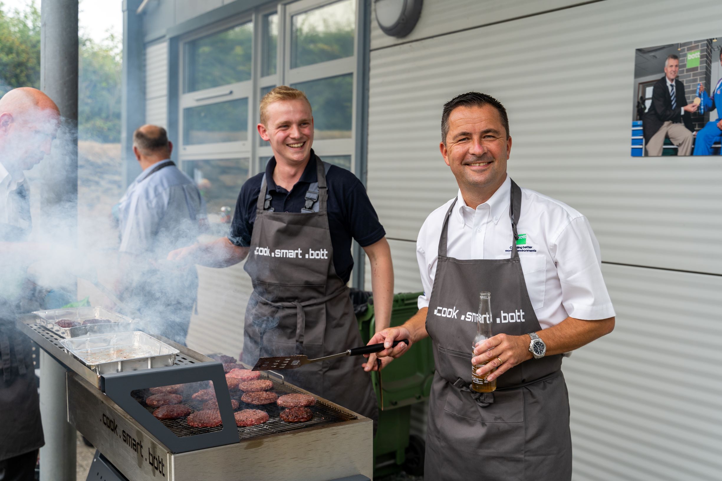 two men hosting a bbq at the bott ltd headquarters - van racking experts