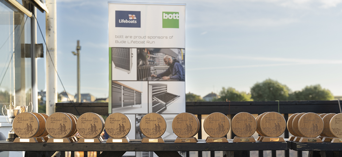 bude lifeboat run trophies lined up on table - celebrating bott ltd's sponsorship