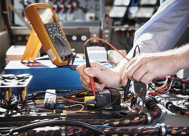 engineer working on electrical van conversion parts - van racking & electric conversion specialists